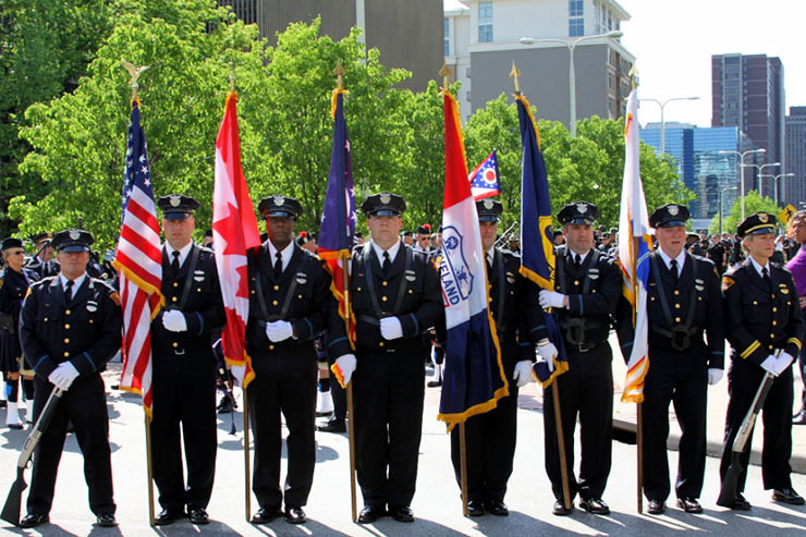 Police officers with flags at their sides at the 2015 Memorial Service