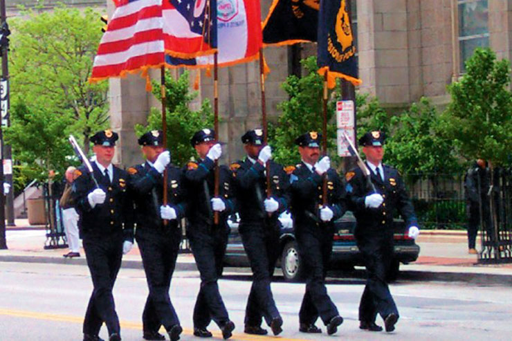 Police officers marching with flags at the parade